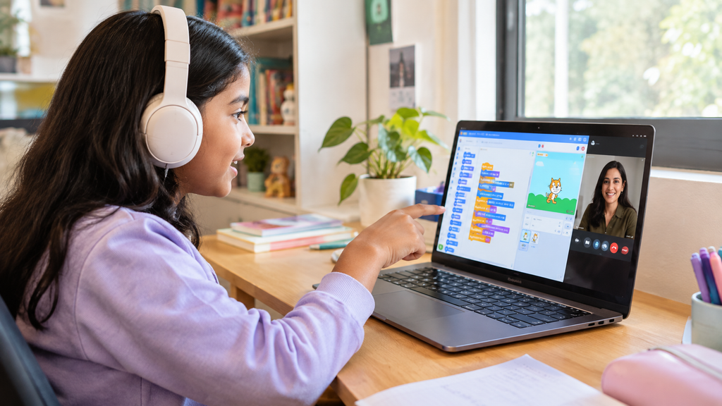 Girl in a live online coding class with a mentor, building a Scratch project