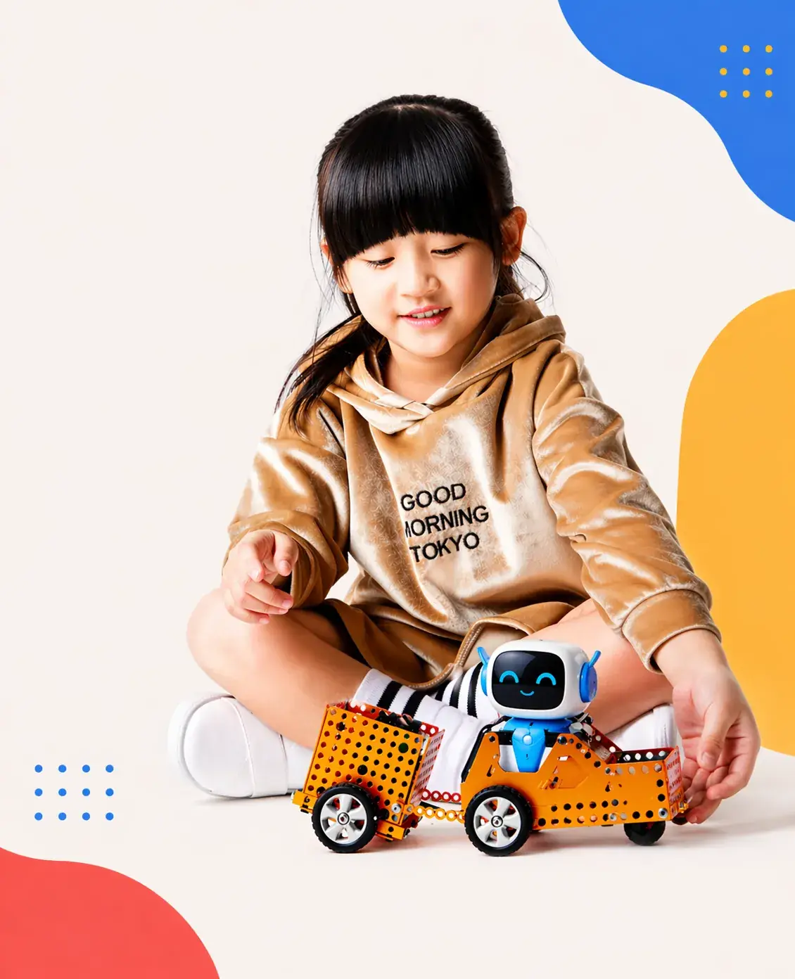 Child assembling and playing with the robot vehicle built from the ItsMyBot STEM kit